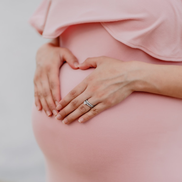 pregnant woman cradling her belly